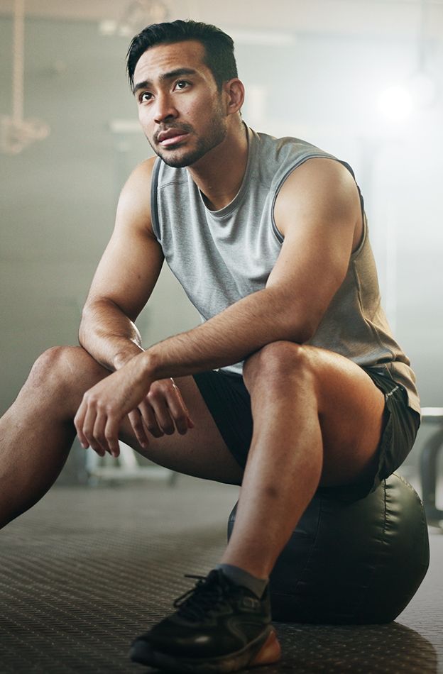 Hyperbaric Oxygen Therapy model resting on a gym ball, thinking.