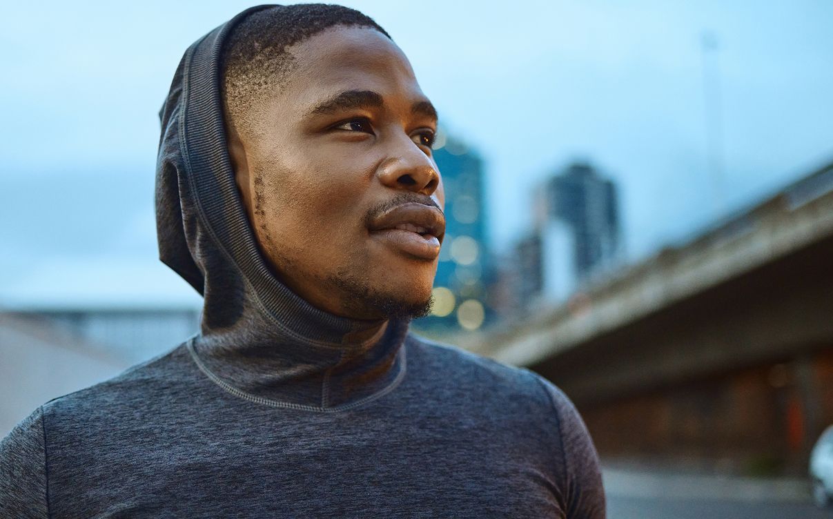 Dallas Hyperbaric Oxygen Therapy model gazing thoughtfully in urban setting.